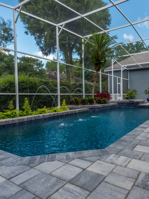 beautiful pool resurfaced in caribbean blue mini pebble with new brick paver pool deck in gray