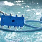 Man holding an equipment for cleaning swimming pool