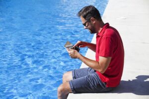 man checking pool automation