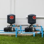 Two pool pump systems with blue plumbing for homeowners asking, “Can a pool go without a pool pump?
