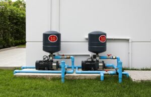 Two pool pump systems with blue plumbing for homeowners asking, “Can a pool go without a pool pump?